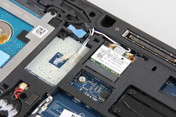 Disconnect the two antennas and remove one screw securing the wireless card