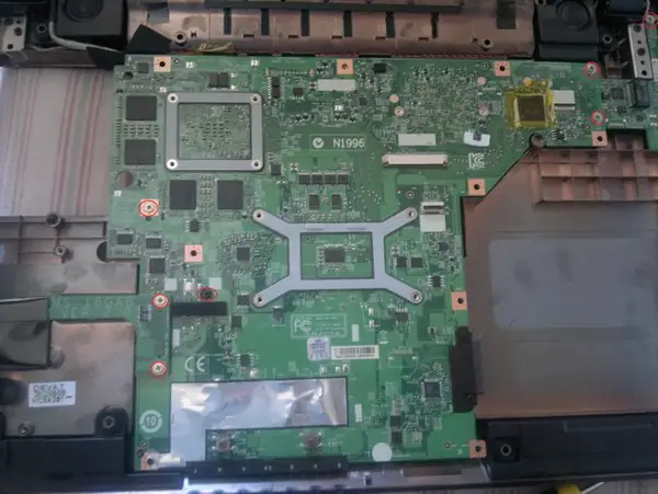 Remove the seven screws securing the motherboard