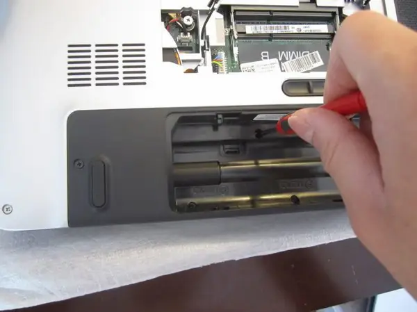 Remove one screw securing the palm rest