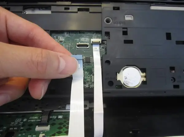 Disconnect the touchpad cable and the power button cable
