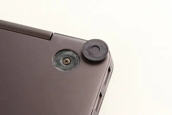 Remove the screws under the rubber pads