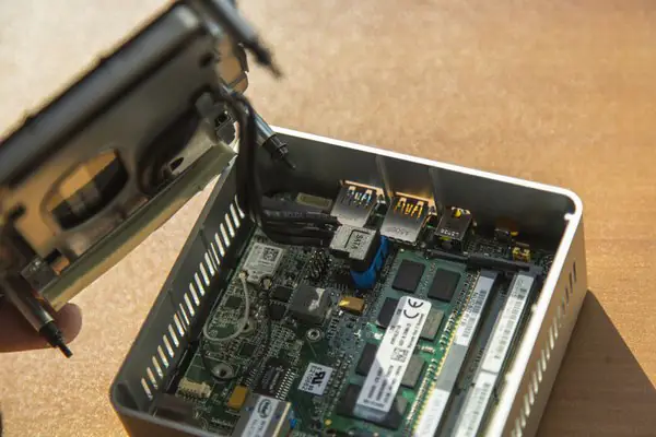 Disconnect the two cables from the motherboard
