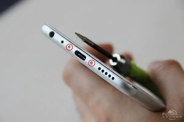 Remove the two screws beside the USB Type-C port