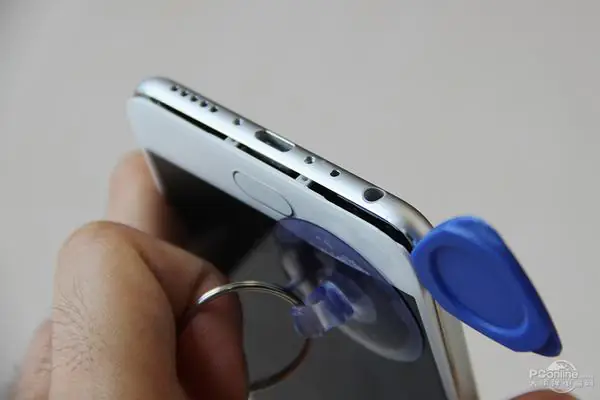 Insert a pick between the display and the middle frame