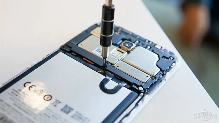 Remove all screws securing the plastic cover.