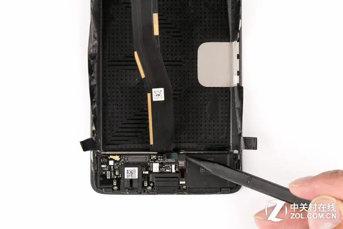 Disconnect the two cables from the sub-board