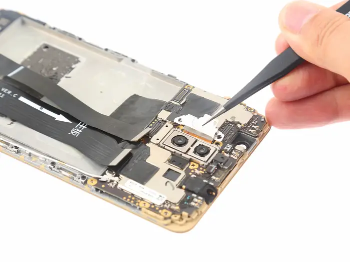 Remove the metal plate that covers the rear camera connector