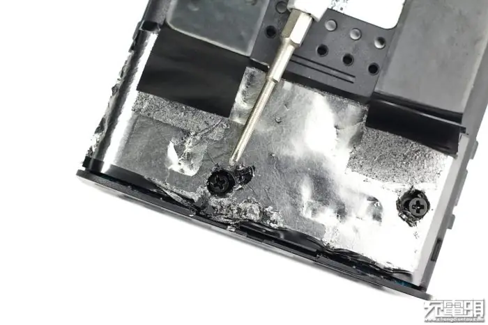 Remove the two screws securing the middle frame